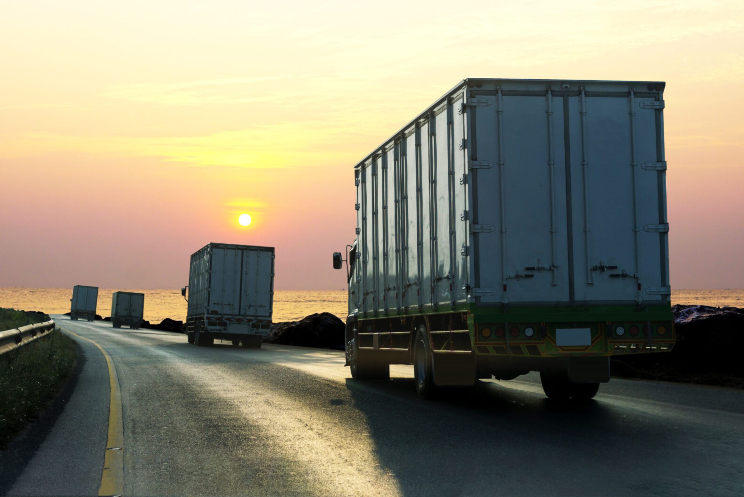 truck-on-highway-road-with-container-logistic-industrial-transport-with-sunrise-sky-scaled